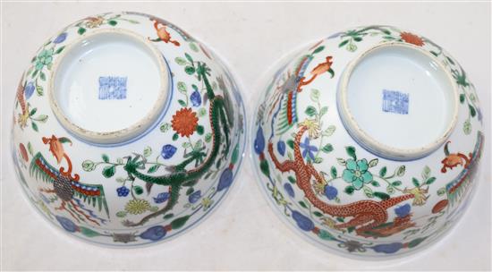 A pair of Chinese wucai dragon and phoenix bowls, Qianlong seal marks, late 19th/early 20th century, 18cm, small rim chips